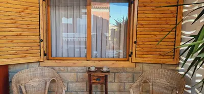 two chairs sitting in front of a window at Chalet Playa Chilches in Chilches