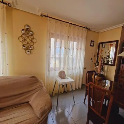 a bedroom with a bed and a table and a window at Chalet Playa Chilches in Chilches
