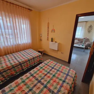a hotel room with two beds and a living room at Chalet Playa Chilches in Chilches