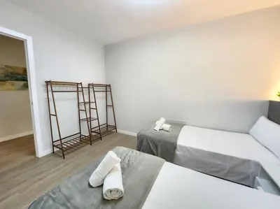 a white room with two beds and two mirrors at Arquitecto D in Valencia