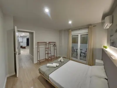 a bedroom with a large bed with two towels on it at Arquitecto D in Valencia