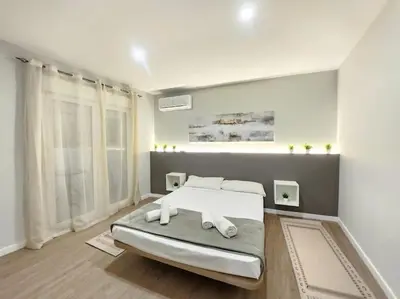 a bedroom with a bed with two towels on it at Arquitecto D in Valencia
