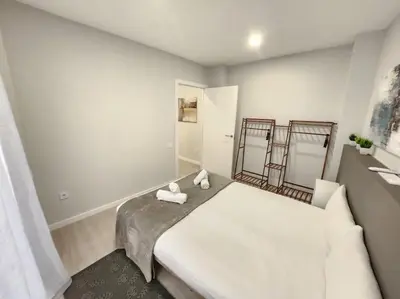 a bedroom with a large bed with two towels on it at Arquitecto I in Valencia
