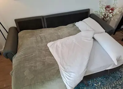 a bed with two pillows on top of it at Arquitecto I in Valencia
