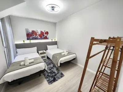 a small room with two beds and a ladder at Arquitecto I in Valencia