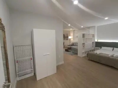 a large white room with a bed and a couch at Explore Valencia! Tirant, city of science & Ruzafa in Valencia