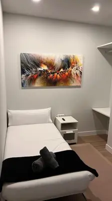 a bedroom with a bed and a painting on the wall at Explore Valencia! Tirant, city of science & Ruzafa in Valencia