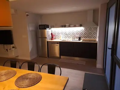 a kitchen with a table and chairs and a refrigerator at Explore Valencia! Tirant, city of science & Ruzafa in Valencia