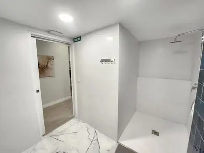 a white bathroom with a shower and a glass door at Valencia experience! Plus,science city & Ruzafa in Valencia