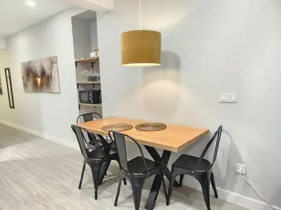 a dining room with a wooden table and black chairs at Valencia experience! Plus,science city & Ruzafa in Valencia