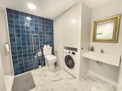 a bathroom with a toilet and a sink and a washing machine at Valencia experience! Plus,science city & Ruzafa in Valencia
