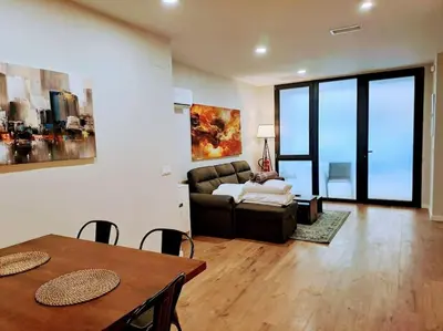 a living room with a couch and a table at Artes y ciencias D with fast Wifi and terrace in Valencia
