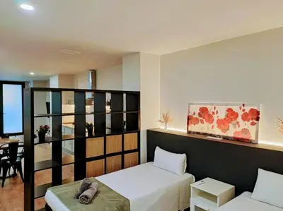 a living room with a bed and a couch at Artes y ciencias D with fast Wifi and terrace in Valencia