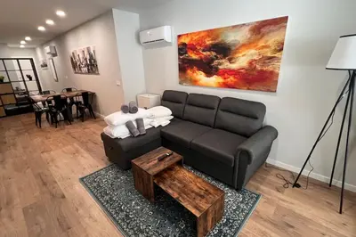 a living room with a couch and a table at Artes y ciencias D with fast Wifi and terrace in Valencia