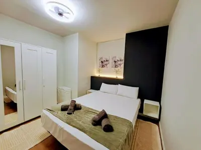 a bedroom with a bed with two brown slippers on it at Artes y ciencias D with fast Wifi and terrace in Valencia