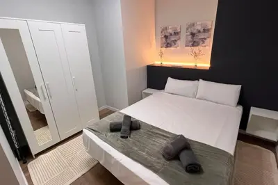 a small bedroom with a bed and a mirror at Las Artes y las Ciencias I in Valencia
