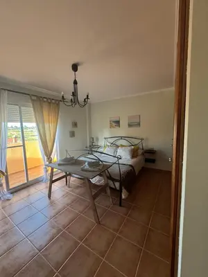 a living room with a table and a bed and a window at La Casa del Olivo en Montserrat - Valencia in Valencia