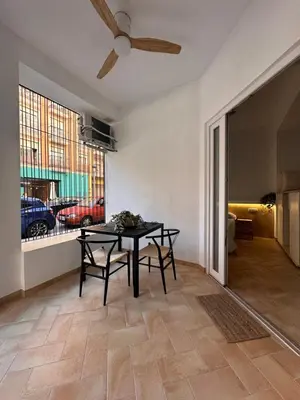 a dining room with a table and a window at Apartamento mediterráneo in Valencia