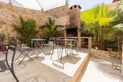 a patio with tables and chairs and a fireplace at Las Golondrinas Experiencia Rural in Quesa