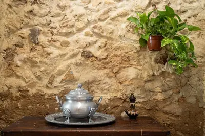 a tea pot sitting on a table with a plant at Las Golondrinas Experiencia Rural in Quesa