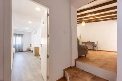 an open hallway with a bedroom and a living room at Casa rural las golondrinas in Quesa