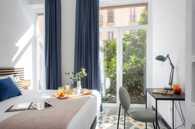 a bedroom with a bed with a tray of food on it at SingularStays Ca Iconic in Valencia