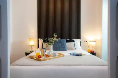 a tray of fruit on a bed with two lamps at SingularStays Ca Iconic in Valencia