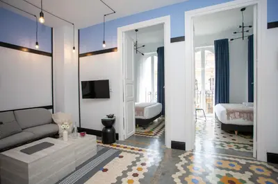 a living room with a couch and a tv at SingularStays Ca Iconic in Valencia