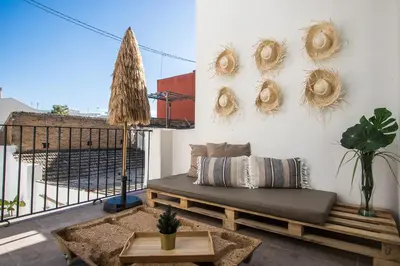 a living room with a couch and a wall with wreaths at MD Jorda Roig Arena in Valencia