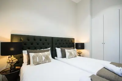 two beds with white sheets and pillows in a bedroom at MD Jorda Roig Arena in Valencia