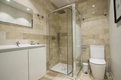 a bathroom with a shower and a toilet and a sink at MD Jorda Roig Arena in Valencia