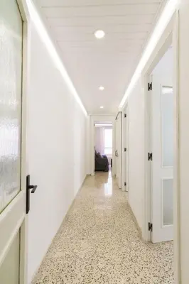 a hallway with white walls and a white floor with a hallwayngth at GuestReady - El Cabanyal stay near the beach in Valencia