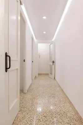 a hallway with white walls and a white door at GuestReady - El Cabanyal stay near the beach in Valencia