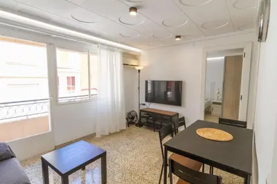 a living room with a table and chairs and a couch at GuestReady - El Cabanyal stay near the beach in Valencia