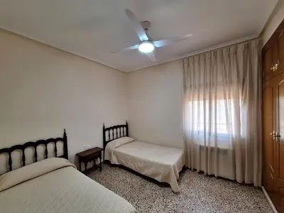 a bedroom with two beds and a ceiling fan at Villa cerca de Valencia con piscina junto a la montaña in Vilamarxant