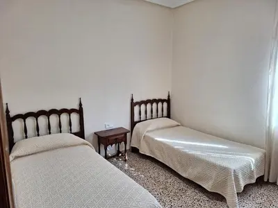 a room with two beds and a table at Villa cerca de Valencia con piscina junto a la montaña in Vilamarxant