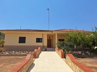 a house with a walkway in front of it at Villa cerca de Valencia con piscina junto a la montaña in Vilamarxant