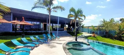a group of chairs and a swimming pool with a building at The Blue Diamond Villa-25min to Valencia in Turís