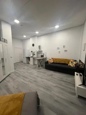 a living room with a couch and a kitchen at Maravilloso Loft - B in Valencia
