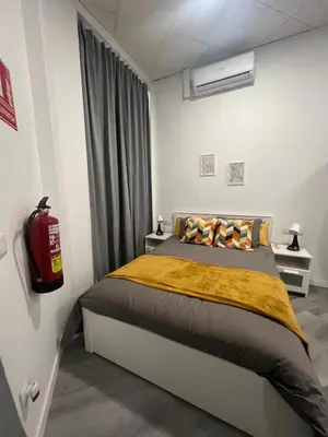 a bedroom with a bed and a fire extinguisher at Maravilloso Loft - B in Valencia