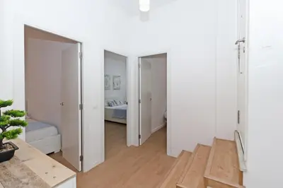 a room with white walls and a hallway with two doors at GuestReady - Lovely flat by Valencia University in Valencia