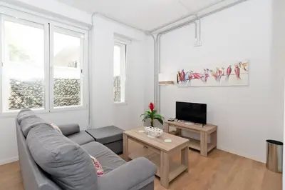 a living room with a couch and a tv at GuestReady - Lovely flat by Valencia University in Valencia
