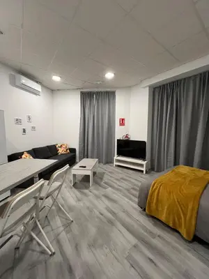 a room with a bed and a couch and a table at Gran loft - A in Valencia