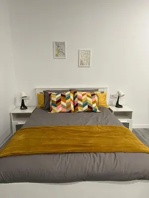 a bedroom with a large bed with two lamps at Gran loft - A in Valencia