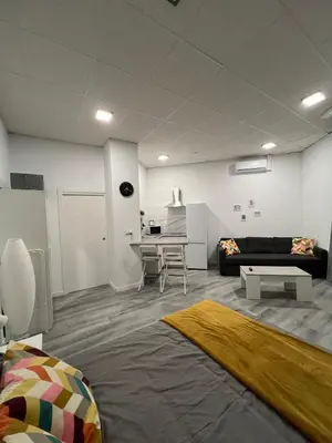 a living room with a couch and a table at Gran loft - A in Valencia