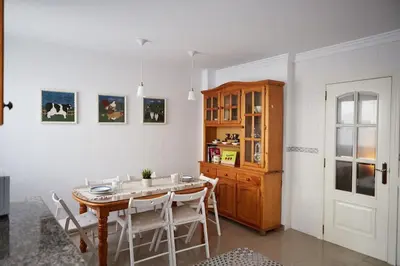 a dining room with a table and chairs and a cabinet at Amplio y cómodo apartamento en el centro in Valencia