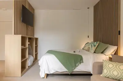 a bedroom with a bed with a flat screen tv at Dorm4You Arena in Valencia