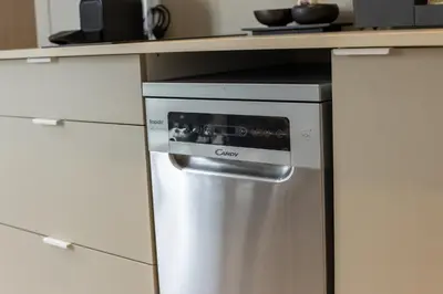 a stainless steel dishwasher in a kitchen with a counter at Dorm4You Arena in Valencia