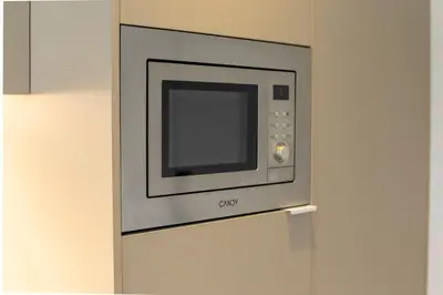 a microwave oven on a wall in a kitchen at Dorm4You Arena in Valencia