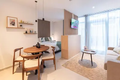 a living room with a table and a bedroom at Dorm4You Arena in Valencia
